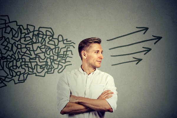 Emotional intelligence concept: A man takes a lot of messy and disjointed input and finds a path forward while remaining calm.