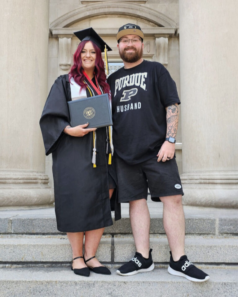 Clad in her cap and gown, Tara Melton poses next to her husband with her diploma in hand. (Photo provided)