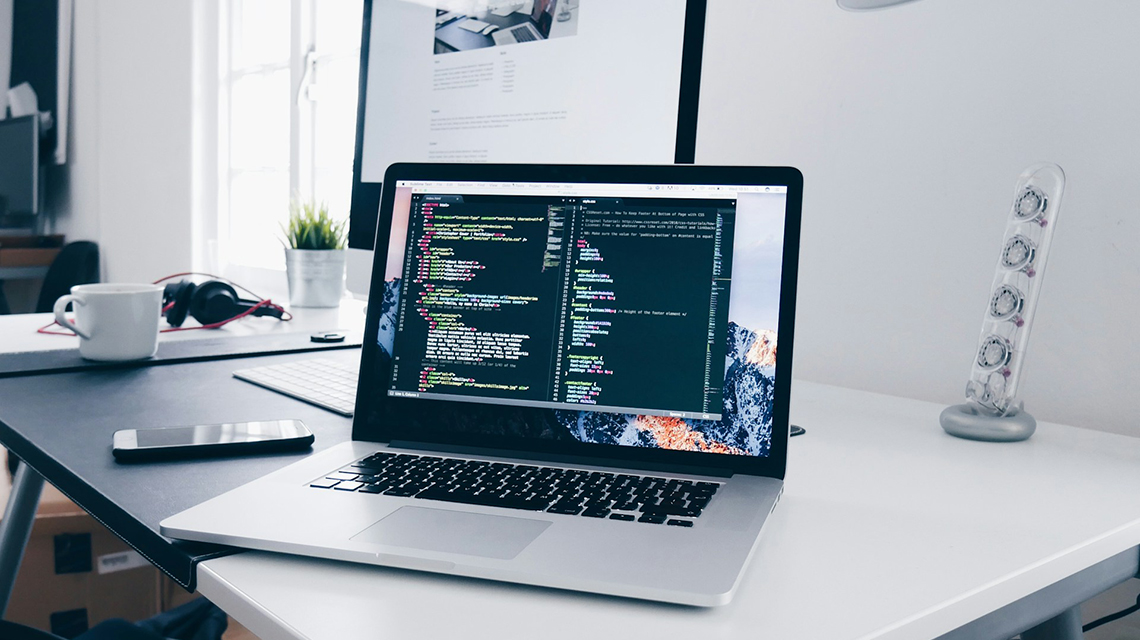 Cap: Kaan Esendemir, a faculty member in Purdue Global’s School of Business and Information Technology, encourages people to develop soft skills in addition to tech skills. (Photo by Christopher Gower/Unsplash)
Alt: A laptop showing code on a desk.