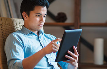 student working on a tablet at home