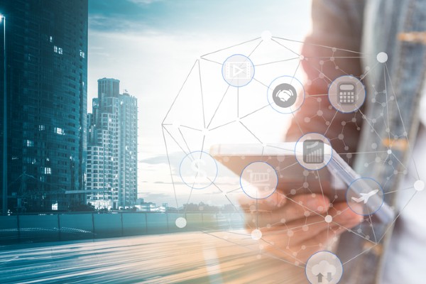 Person using mobile phone with social media networking and business city background