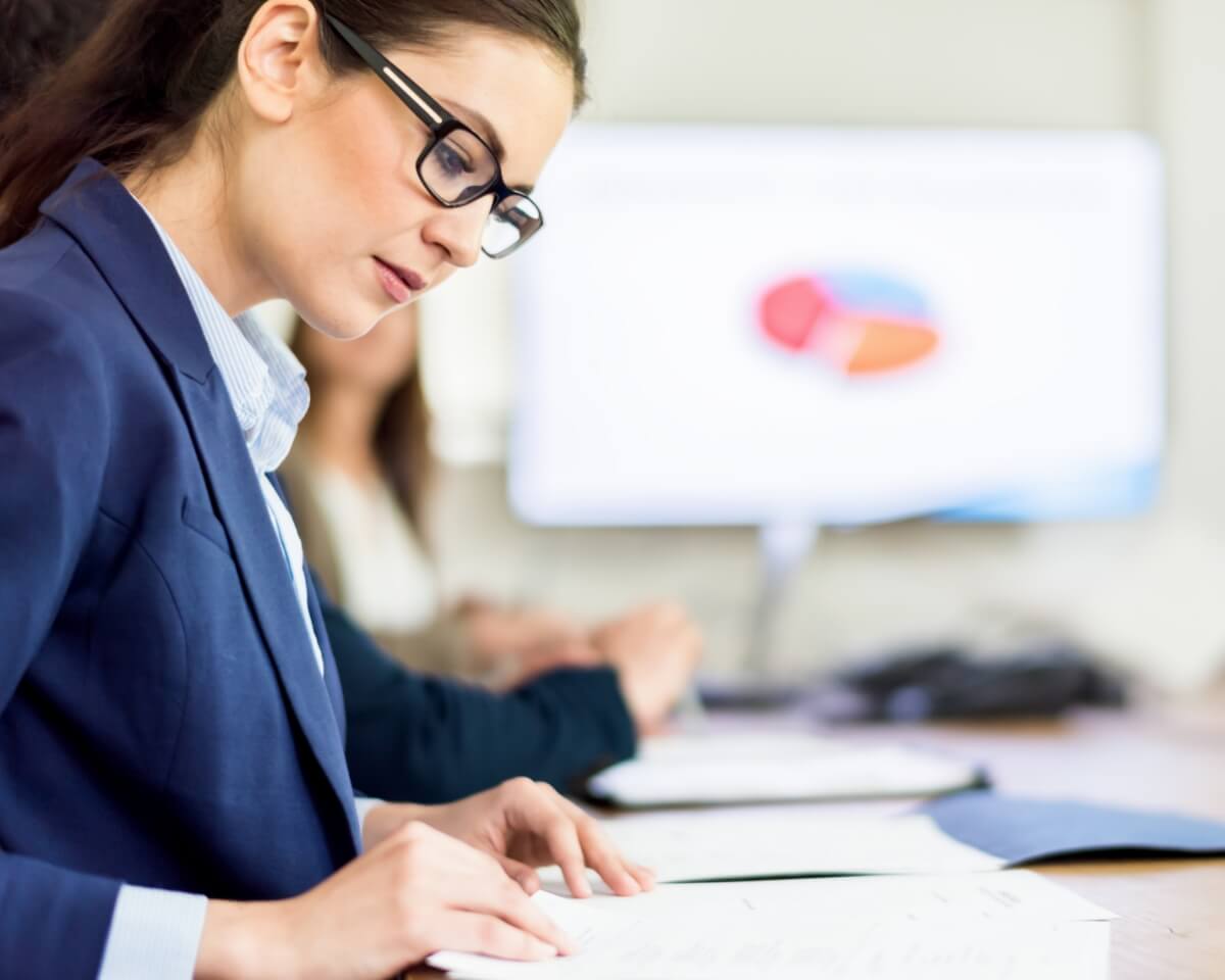 Accounting professionals review documents in a conference room