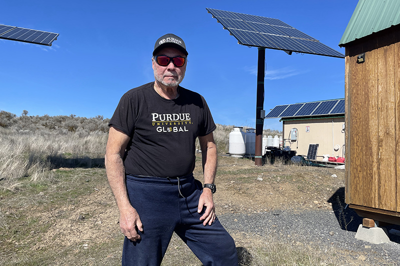 Gustavo “Gus” Gomez standing in a field on his farm