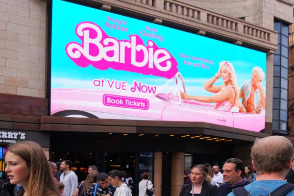 A Barbie movie billboard on a building.
