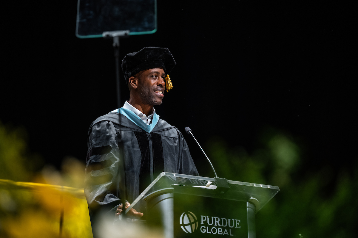 Purdue Global alumnus Kwame Hylton delivers remarks at a commencement ceremony.
