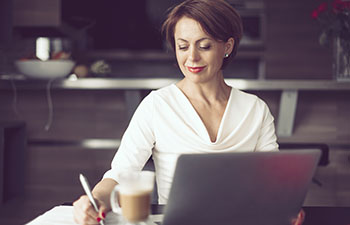 Woman in office looking at laptop