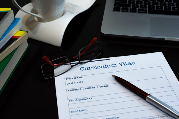 A paper curriculum vitae (CV) on a desk