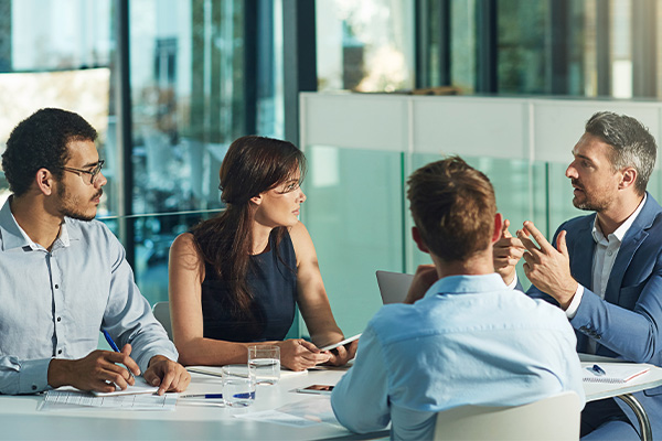 A group of colleagues in a meeting having a conversation.