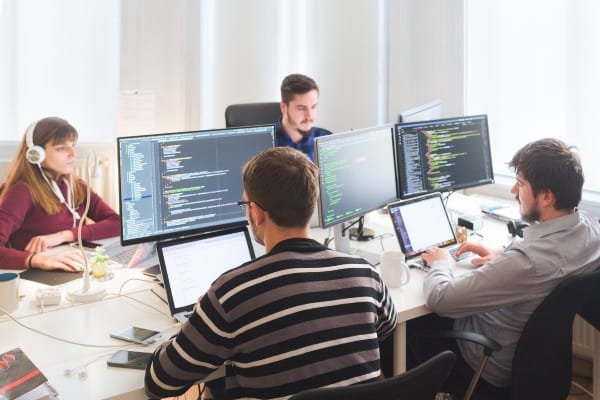 Group of software developers working together at an office
