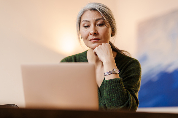A woman studying on a laptop.