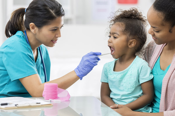 A school nurse examines a child