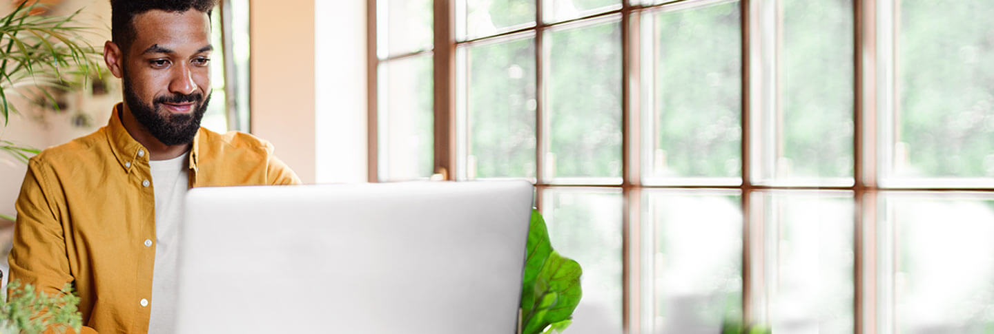 man working on a computer in a bright room