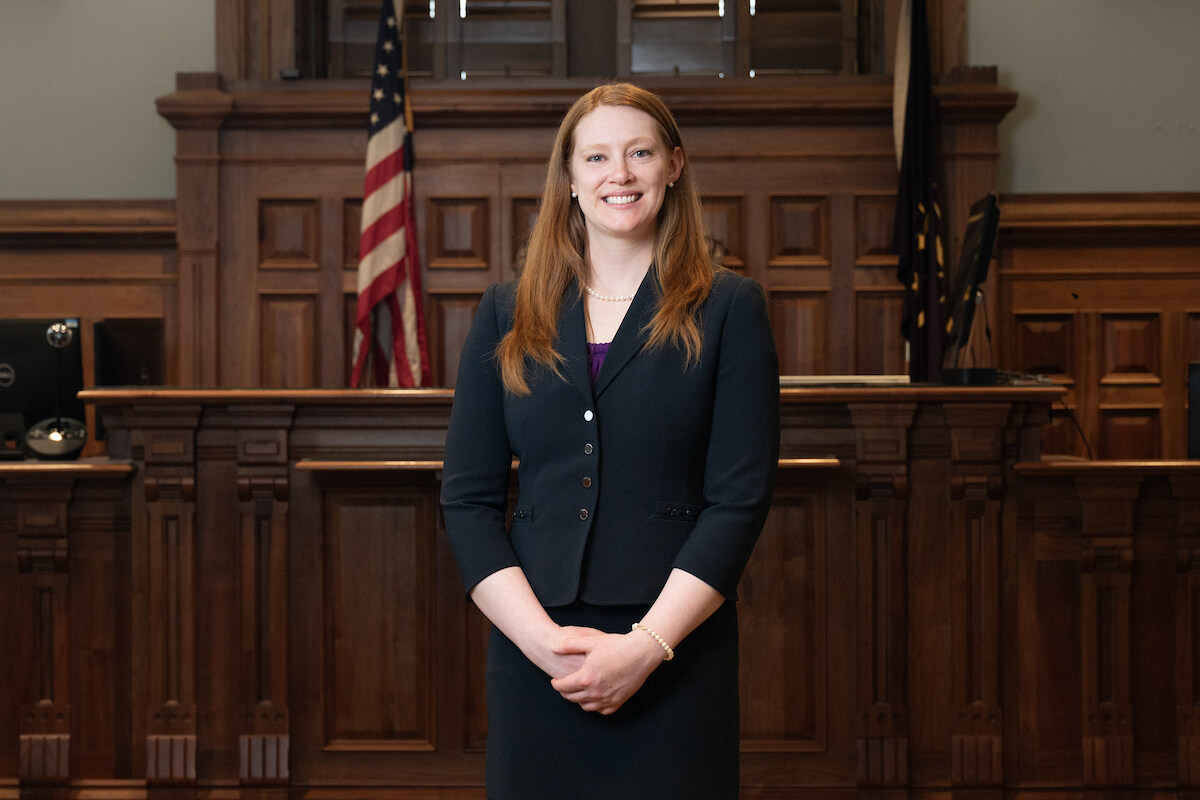 alt: Lauren Mollon stands in a courtroom.