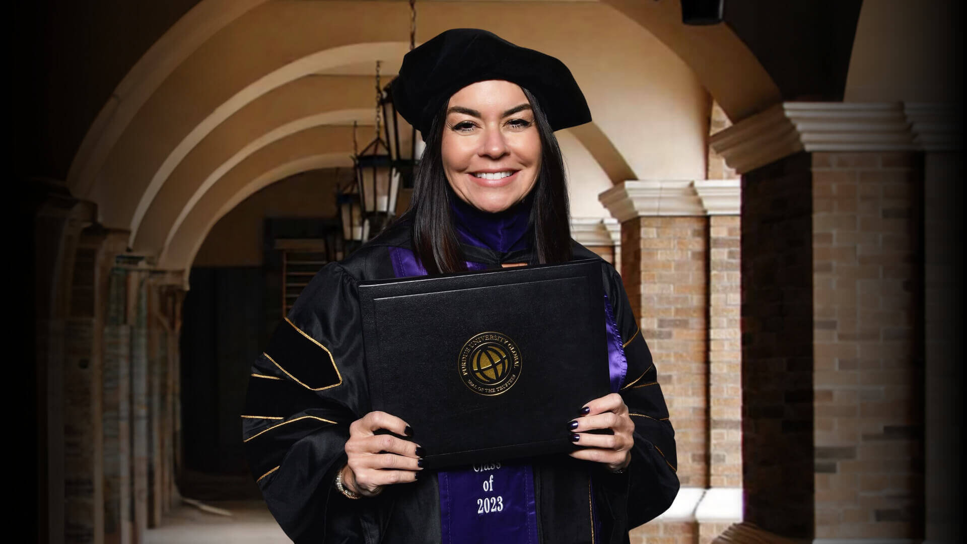Janet Regnier, Purdue Global Law School ’23 graduate holding her diploma