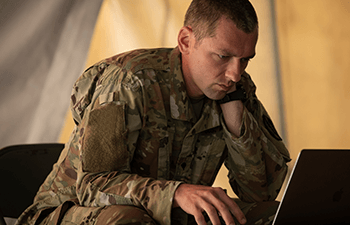 man in uniform on a computer