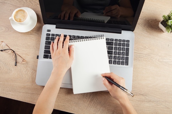 A student is taking handwritten notes.