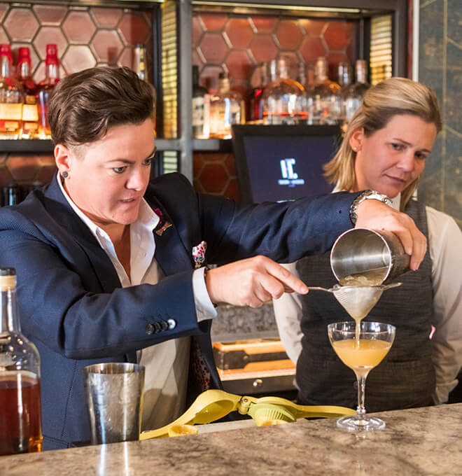 Leanna Chroman, a former bartender at Huse Culinary, pours a mixed drink at the upstairs bar at HC Tavern + Kitchen. (Purdue University photo/John Underwood)