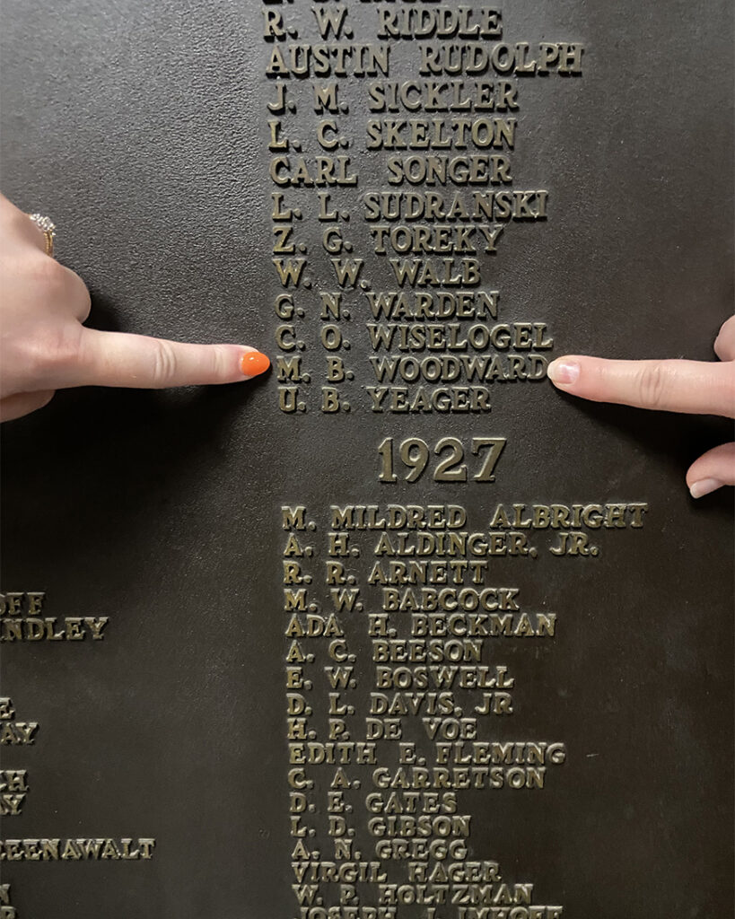 Family members point to Maurice Woodward’s name on a plaque in the Purdue Memorial Union. (Photo provided)