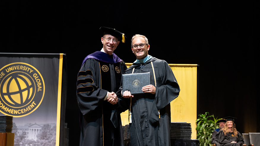 Jon Harbor, Purdue Global’s interim chancellor, with Pat Doney at commencement. Doney served as the commencement speaker during the October ceremonies in West Lafayette. (Purdue Global photo/John Underwood)