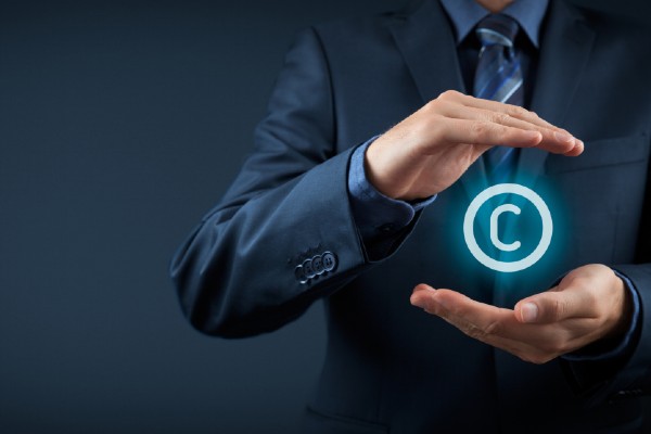 Man's hands with a digital copyright symbol between them