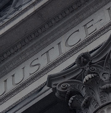 Word Justice carved into a stone building