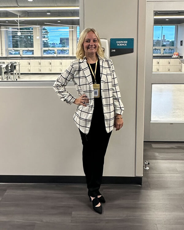 Newhart stands outside of her classroom at the career academy.