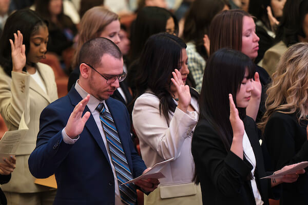 Stefan May stands and raises hand as he is sworn in to the Indiana bar.