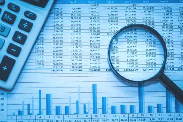 A spreadsheet with a calculator and magnifying glass.