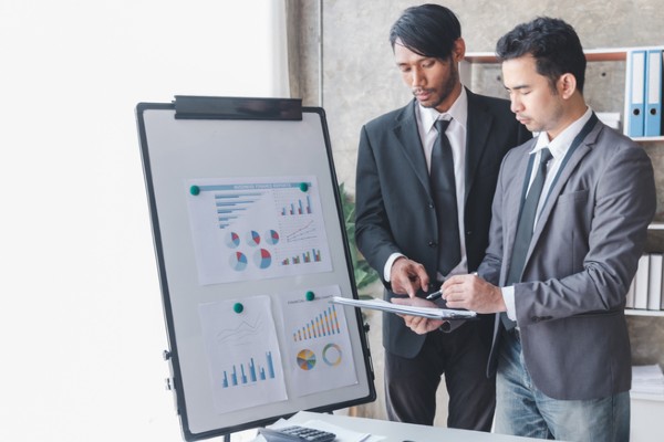 Credit analysts assess risks in a meeting.