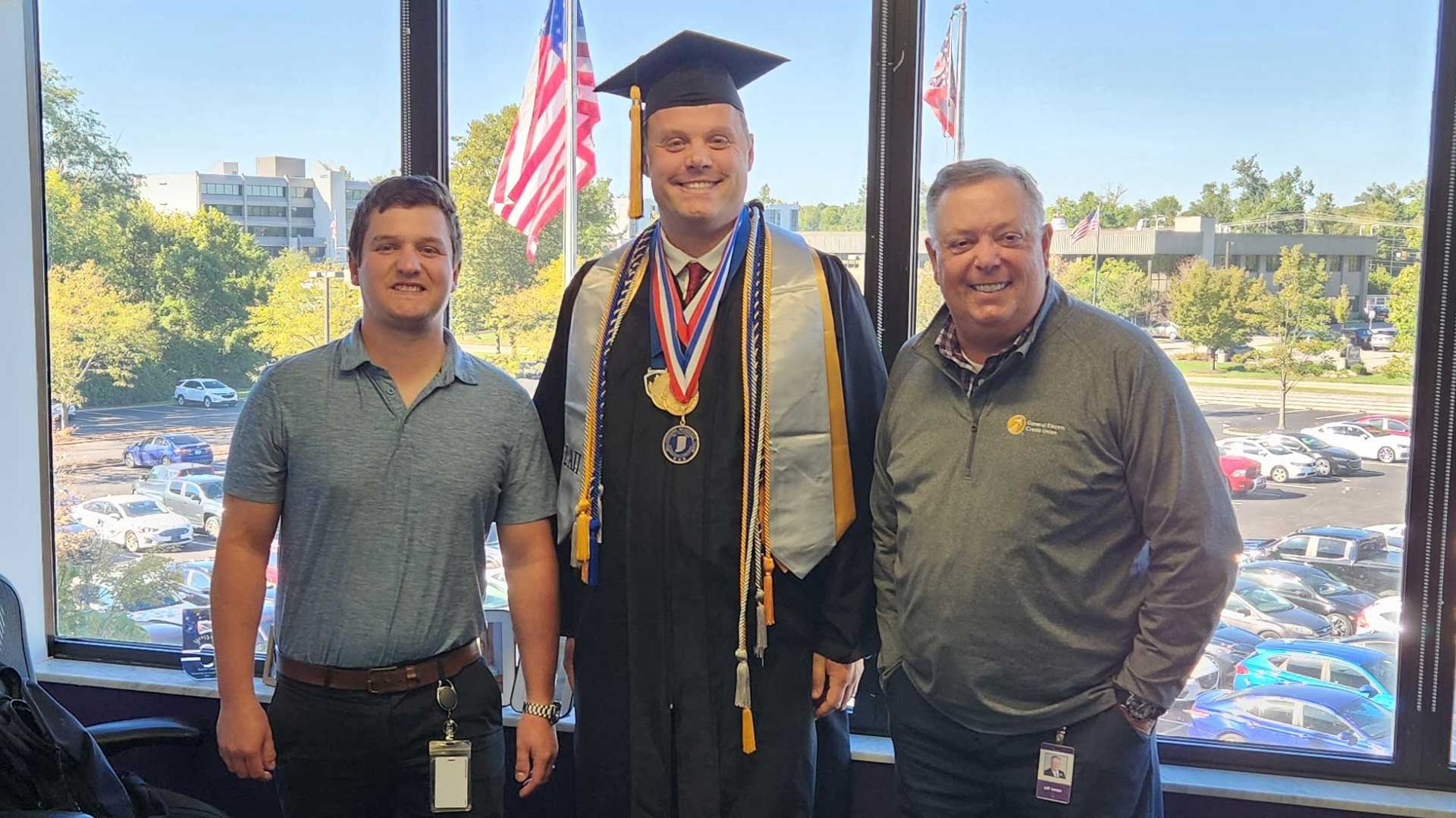Kurtis Ashton celebrates his degree with his General Electric Credit Union colleagues, Austin Vaive (left) and Jeff Lenzer (right). (Photo provided)