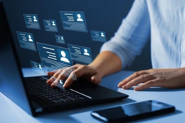 Hands typing on a laptop