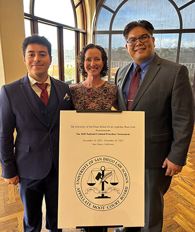 Carlos Cepeda-Ojo, left, and Brian Gatus, right, with their coach, Kelley Mauerman (center).