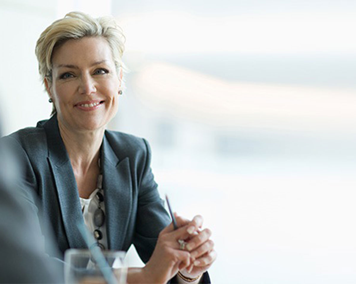 Professional women in grey jacket smiling at camera