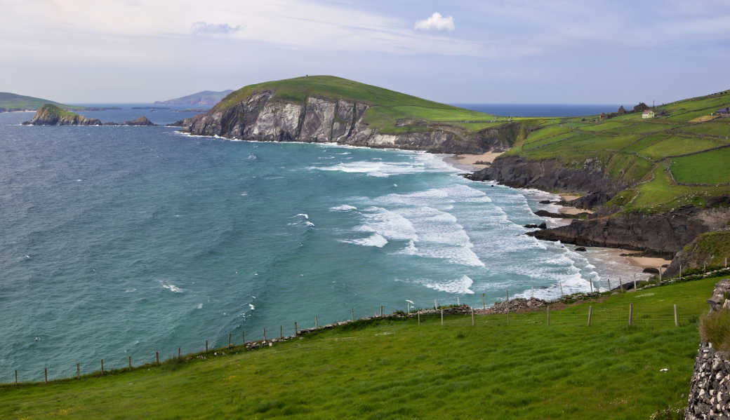A beach in Cork surrounded by pastoral landscapes - discover more on a tour of Ireland.