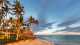 Discover beautiful palm trees and a hut on the Viti Levu Coral Coast Beach.