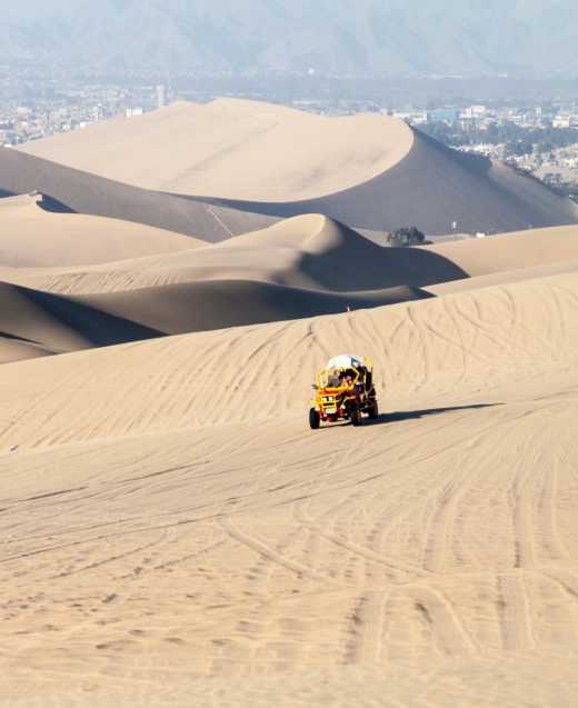 Dünenbuggy fährt über die Sanddünen in der Huacachina-Wüste, Peru.