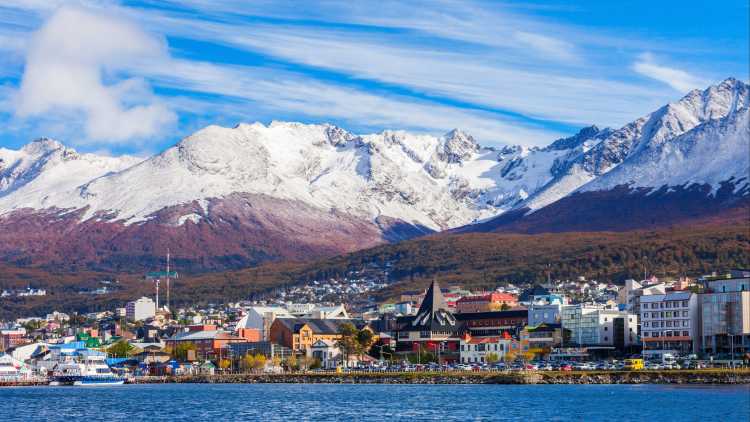 South America, Argentina, view of Ushuaia offshore with snowy mountains in the background.