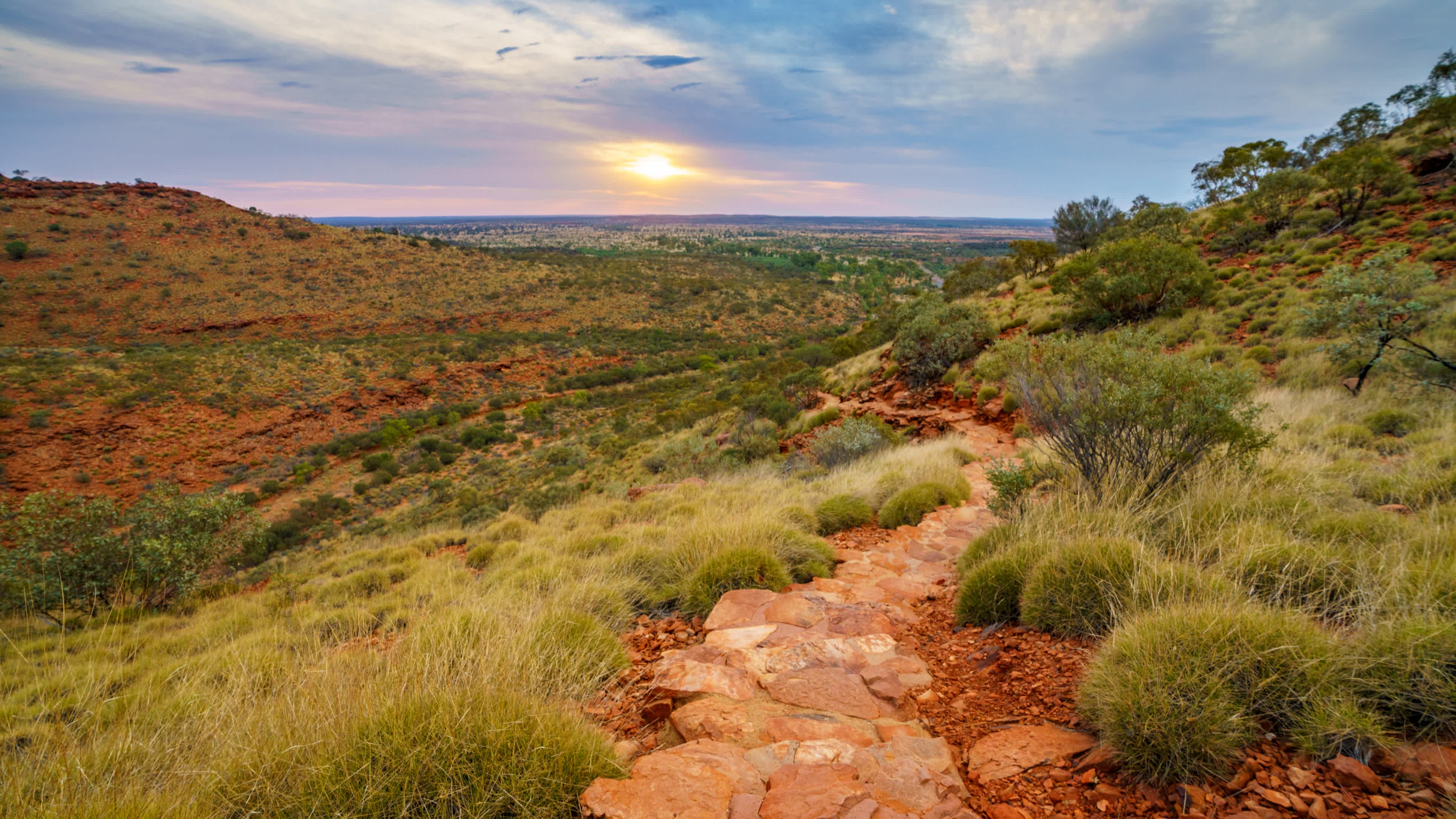 View over the landscape of Watarrka National Park in Australia at sunset.