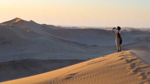 A women photographs the sand dunes in Namibia