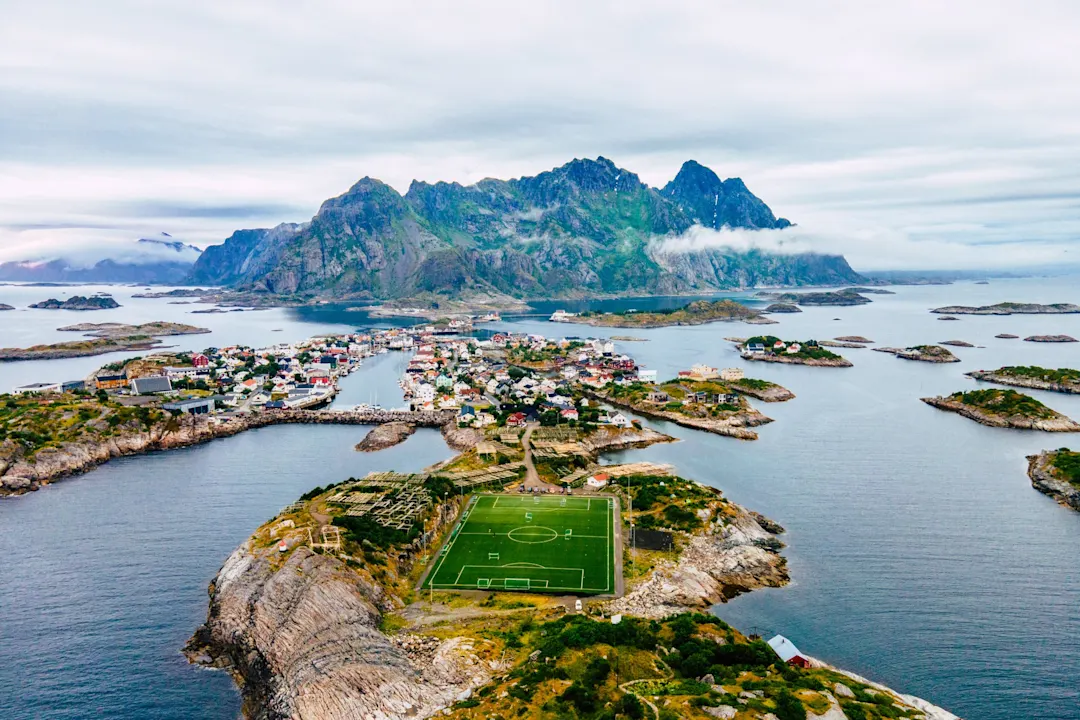 Luftaufnahme des Henningsvaer-Archipels und des Fußballstadions auf den Lofoten, Norwegen.