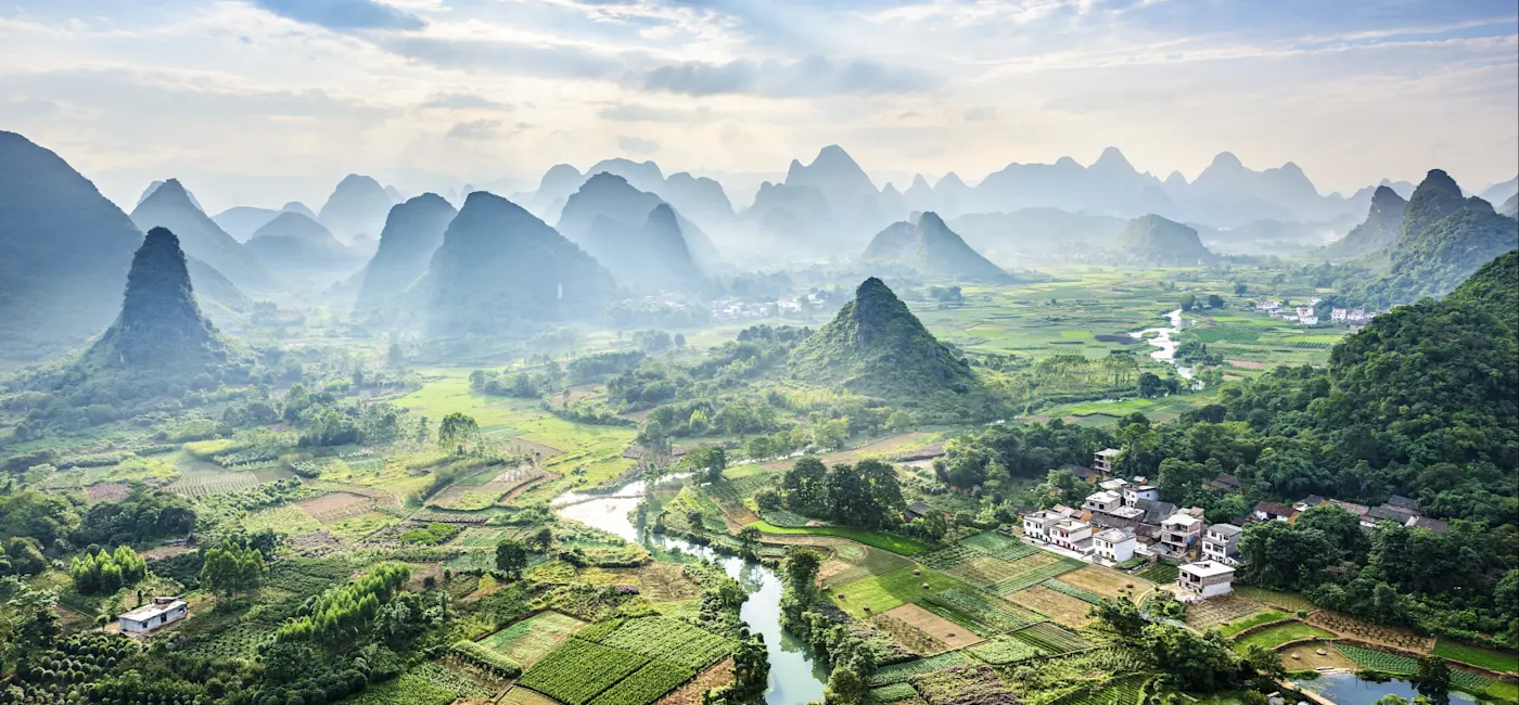Guilin, Guangxi, China Landschaft mit grünen Karstbergen und Feldern im Morgennebel. Guilin, Guangxi, China.