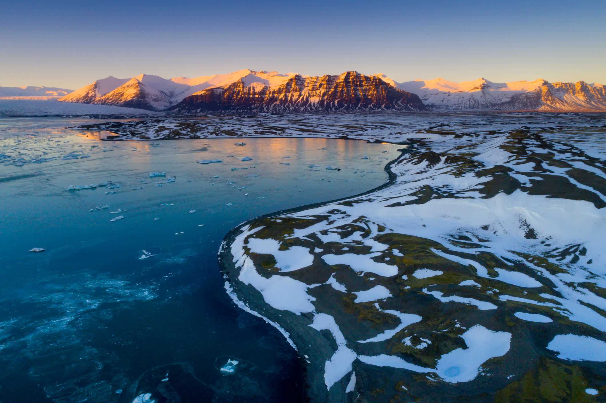 Warme Farben des Sonnenuntergangs über der Gletscherlagune Jökulsarlon in Island