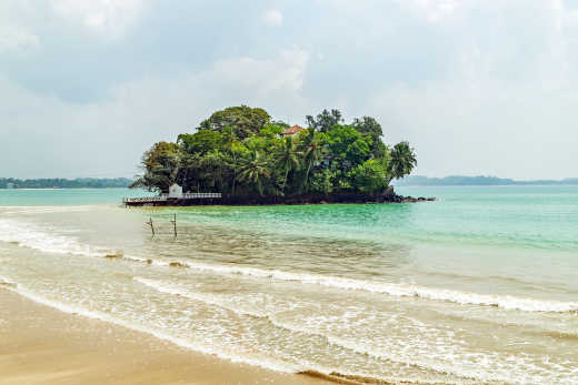 Vue du Seenigama Muhudu Viharaya, entouré de végétation au bord de la mer, à Hikkaduwa, au Sri Lanka.