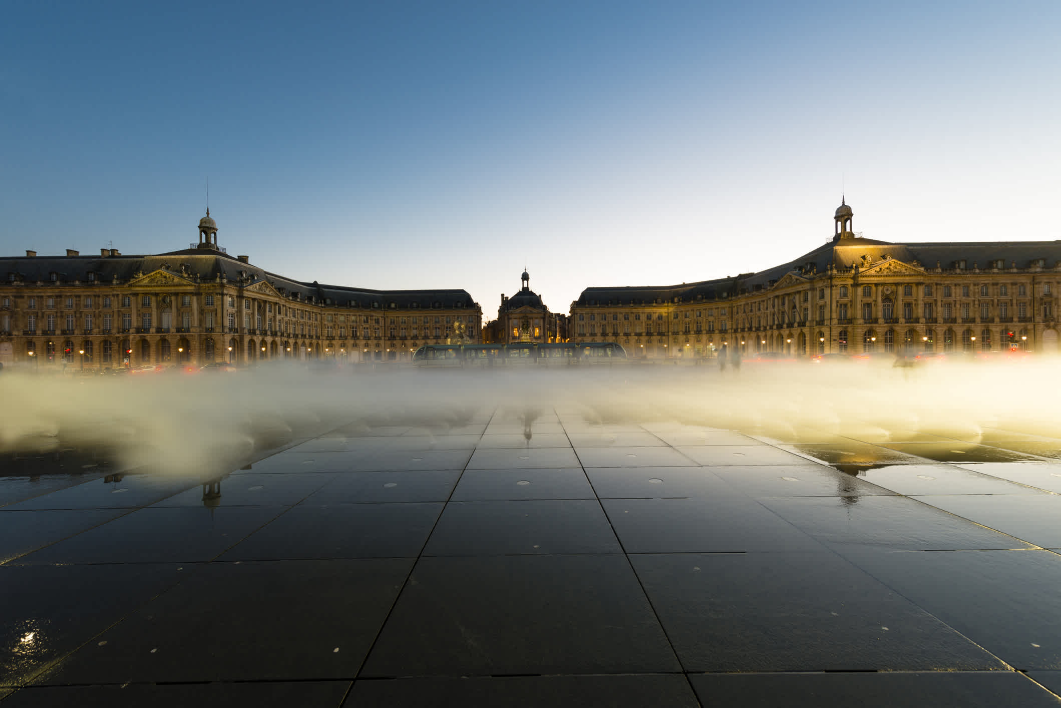 Visit the Place de la Bourse, pictured here under blue sky, on a Bordeaux vacation
