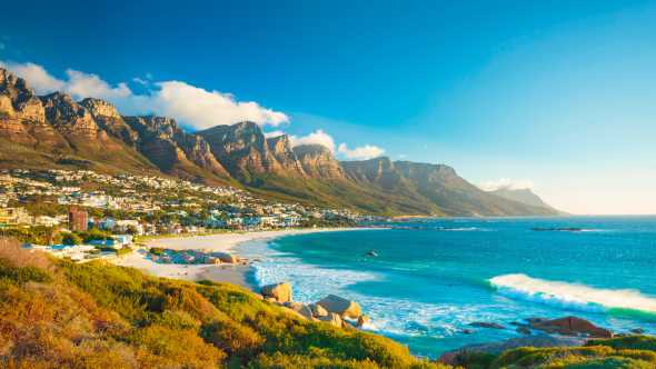 See the shores of Camps Bay and the Twelve Apostles mountain range on a Best of South Africa Tour  