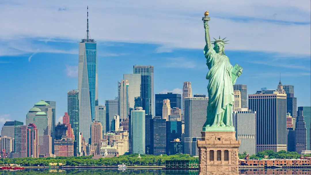 Freiheitsstatue und Skyline von New York City mit Manhattan Financial District, World Trade Center, Empire State Building und Blue Sky, USA.
