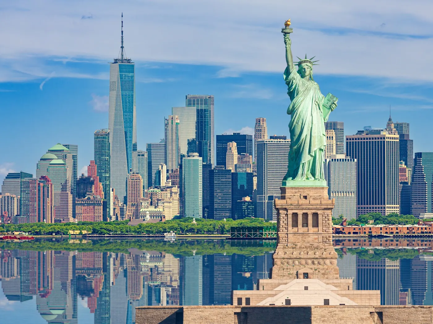 Freiheitsstatue und Skyline von New York City mit Manhattan Financial District, World Trade Center, Empire State Building und Blue Sky, USA.