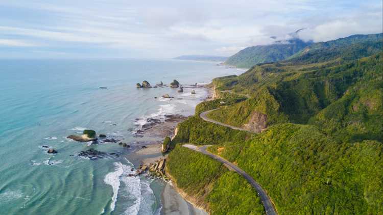 A_road_winds_along_the_pacific_coast_on_the_south_island_of_New_ Zealand