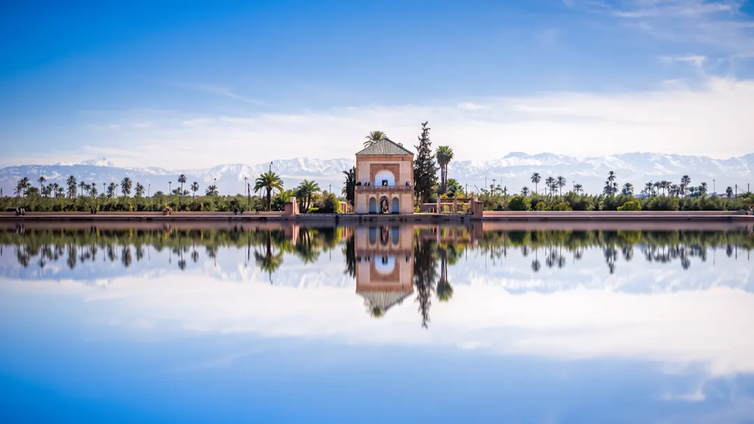 Panoramablick auf den Menara-Pavillon, die Menara-Gärten und das Atlasgebirge in Marrakesch, Marokko, Afrika.

