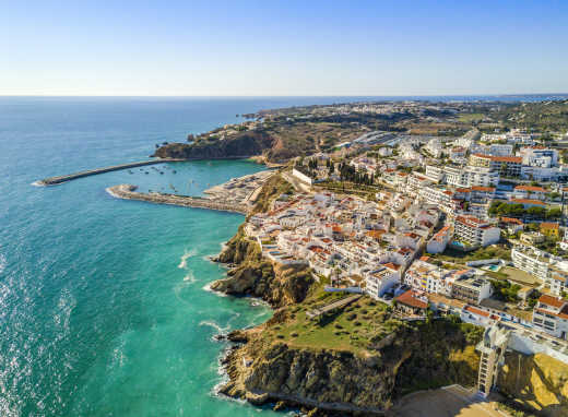 Aerial view of marina and white architecture above cliffs in Albufeira